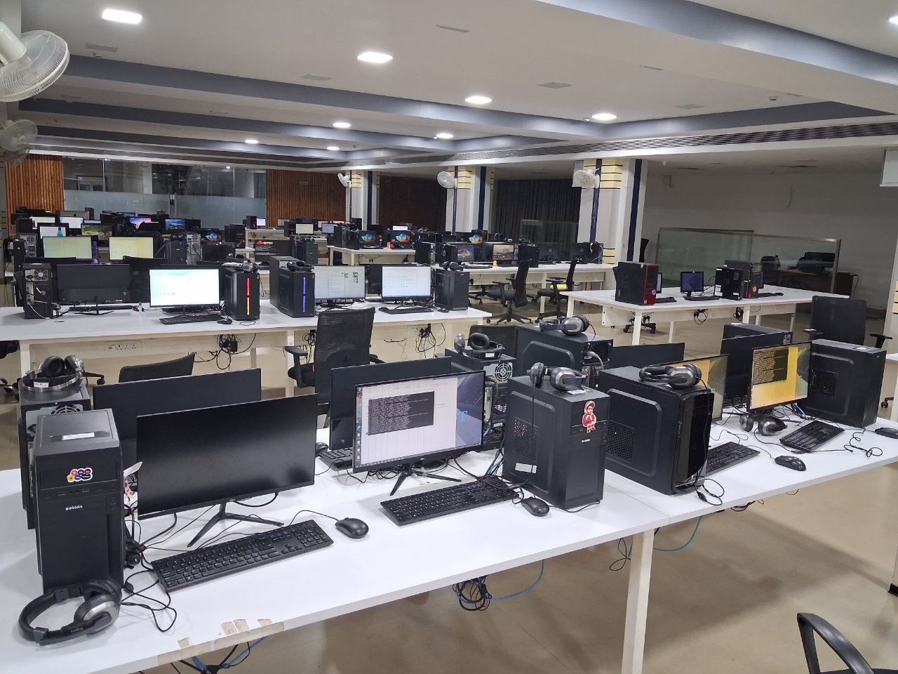 Rows of desks and computers stretching to the back of the office.